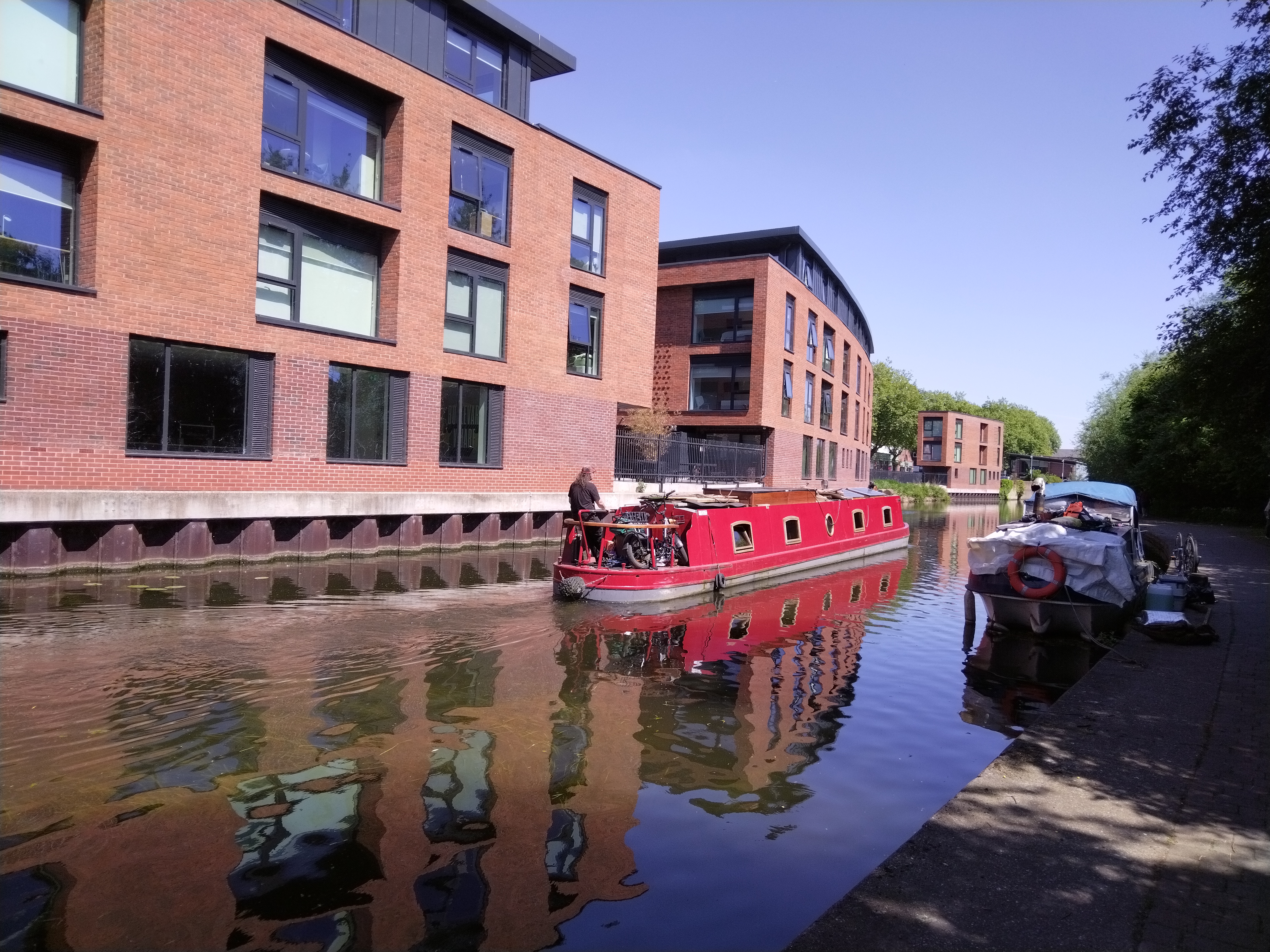 red canal boat on nottingham waterways with blue sky